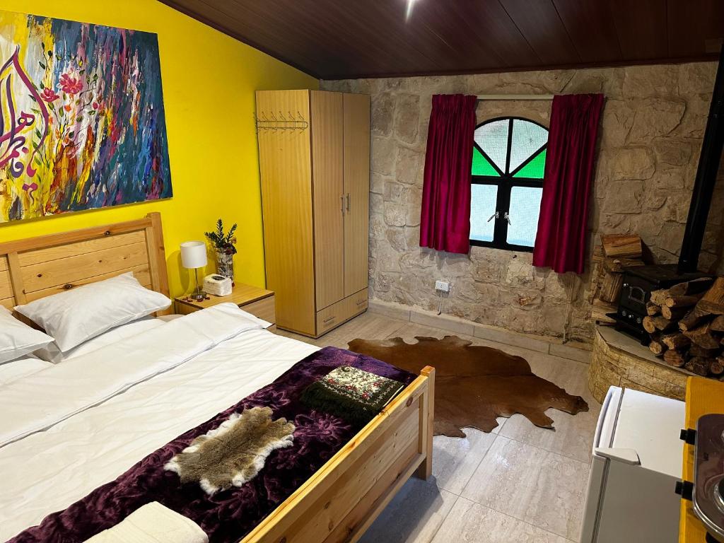 a bedroom with a large bed and a window at The Oasis Healing Resort in Mazraat Kafrâ