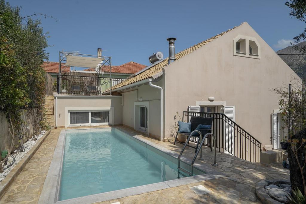 a swimming pool in the backyard of a house at Villa Pilali in Kefallonia