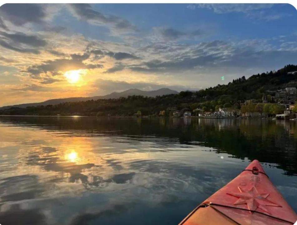 a kayak on a lake with the sun setting at Casa Lu' in Bosisio Parini