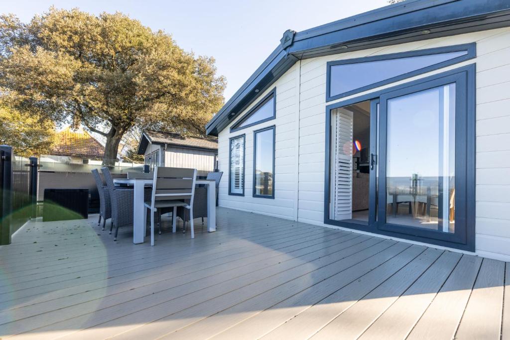 a large deck with a table and chairs at Quayside in Christchurch