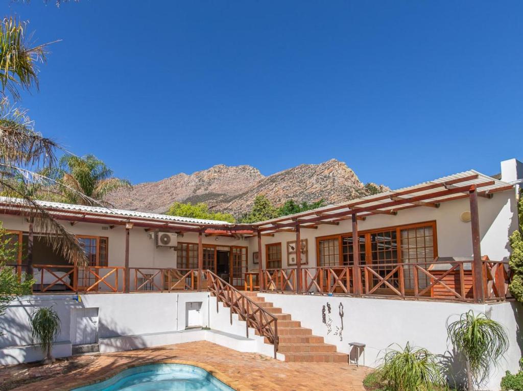 a house with mountains in the background at The Gentleman in Montagu