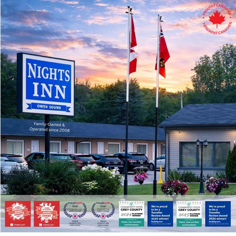 a sign for a north inn with flags in front of it at Nights Inn Owen Sound in Owen Sound