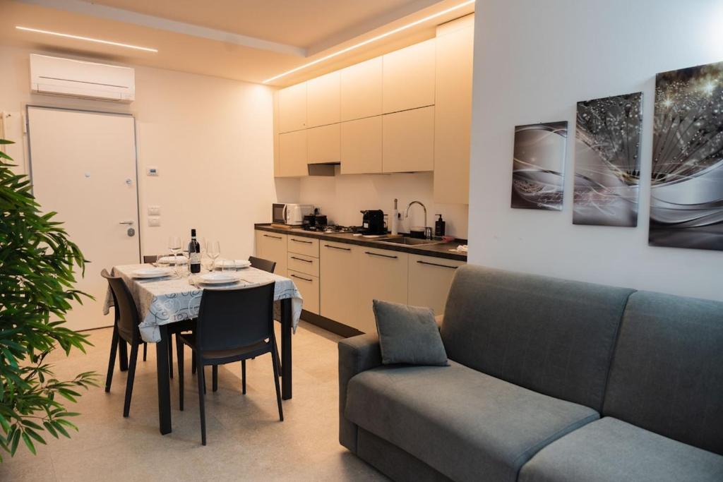 a living room with a table and a couch at Diamante Luxury Apartment in Torri del Benaco