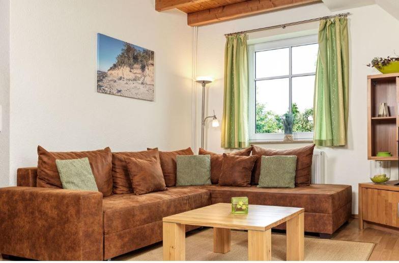 a living room with a brown couch and a table at Nixe in Timmendorf