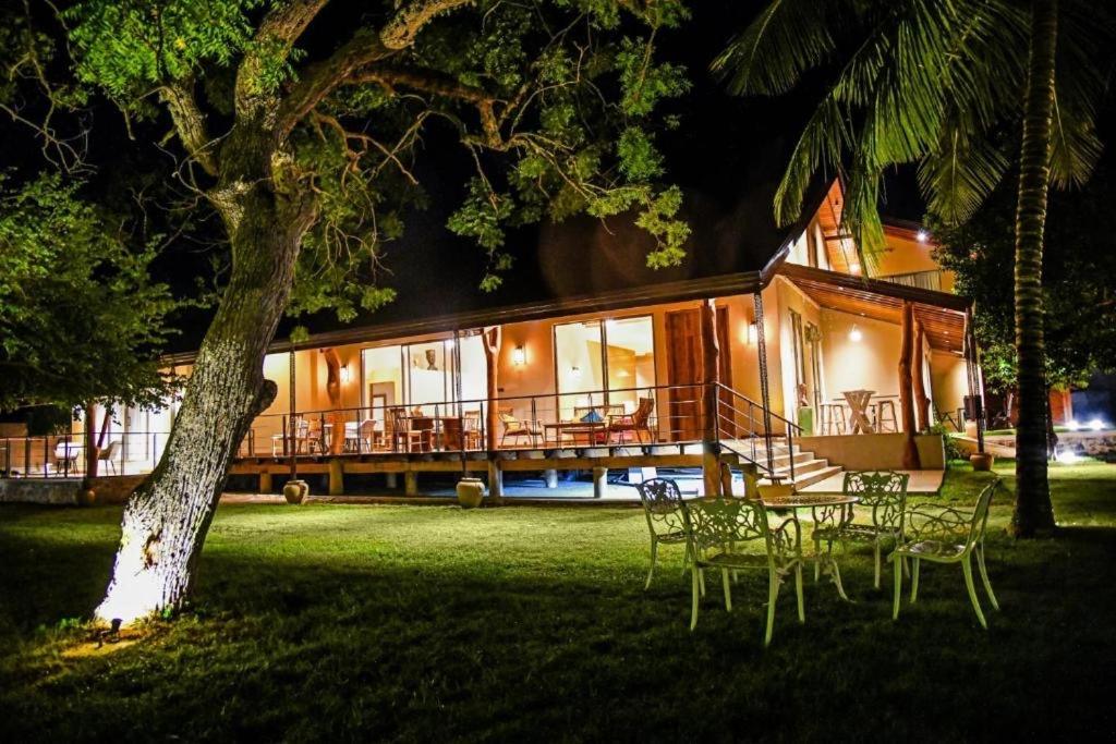 a house with a table and chairs in the yard at Allure Yala Luxury Suites by Allure Leisure in Yala
