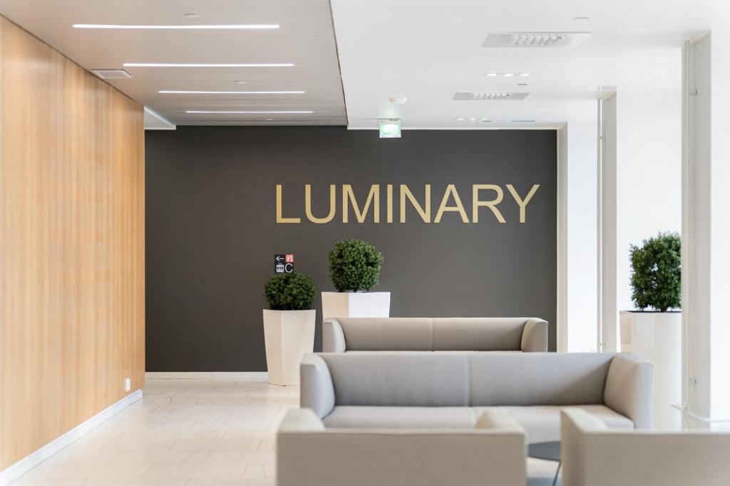 a lobby with a library sign on a wall at Luminary - Tampere City Center Apartments by Come in! in Tampere