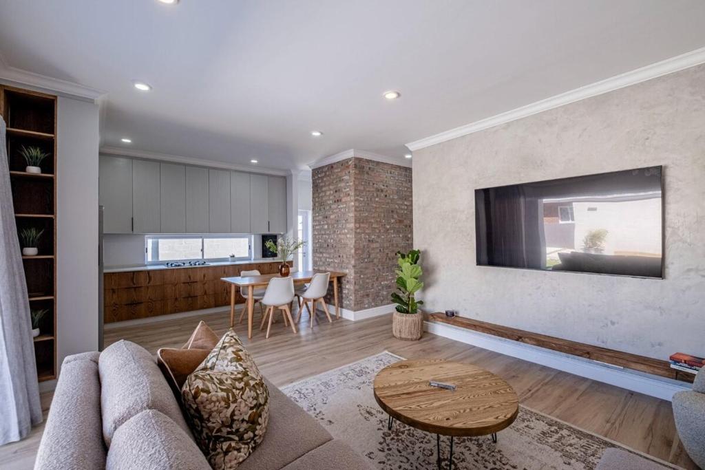 a living room with a couch and a table at The Shirley Too in Gqeberha