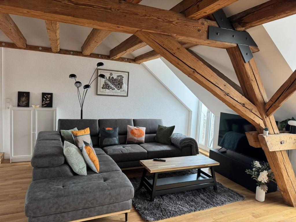 a living room with a couch and a table at Schloss Espasingen Apartment 4 in Stockach