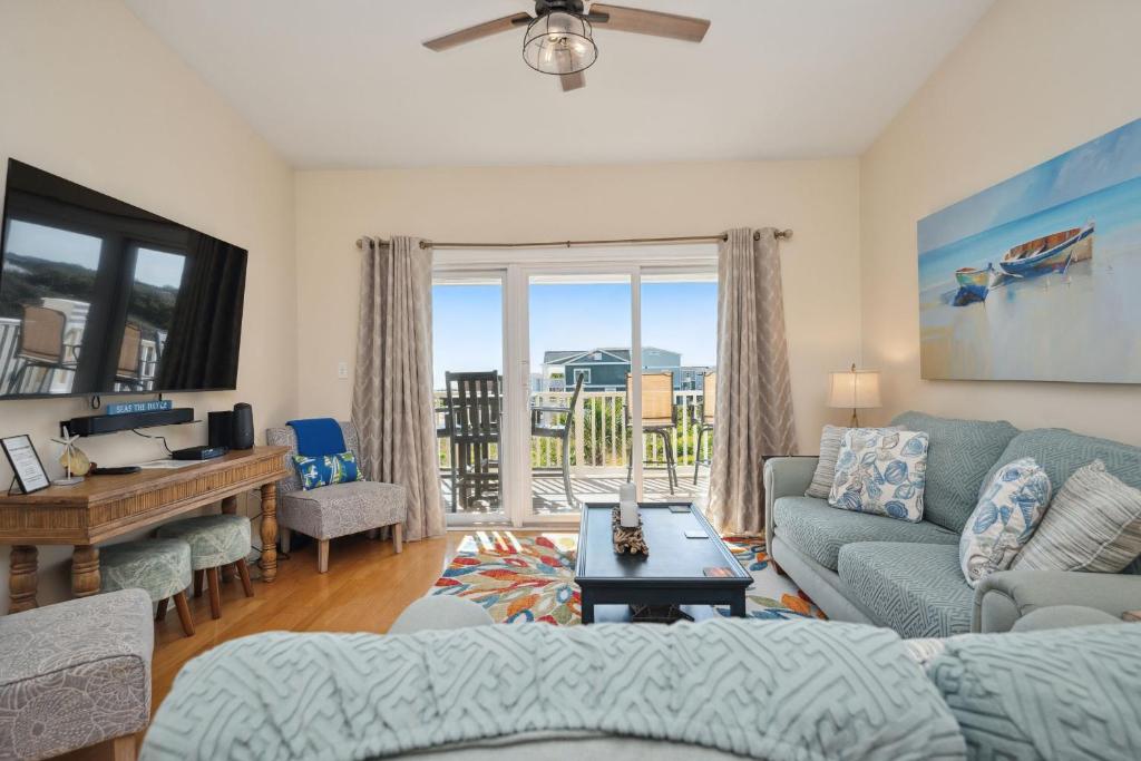 a living room with a couch and a table at Sea Tales by Oak Island Accommodations in Oak Island
