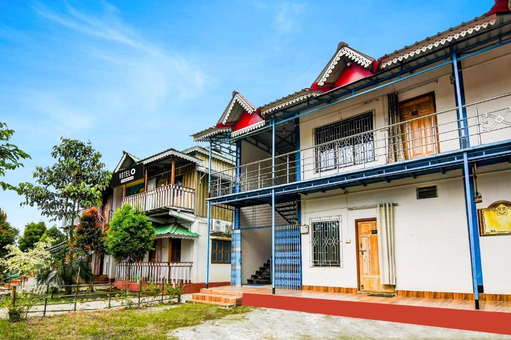 a row of houses with balconies on them at Super Hotel O Chilapata Forest Formerly Moner Manush Homestay in Uttar Simlabari
