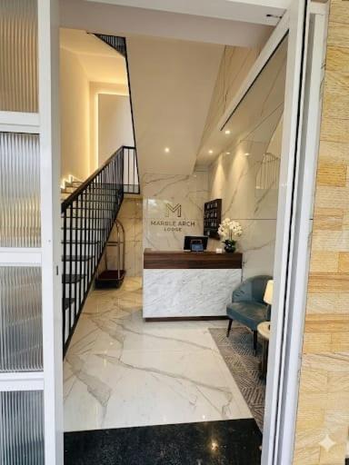 a hallway with a staircase with a blue chair at Castle villa in Cochin