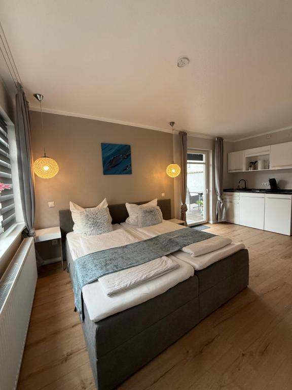 a large bedroom with two beds and a kitchen at Ahr Apart in Dernau