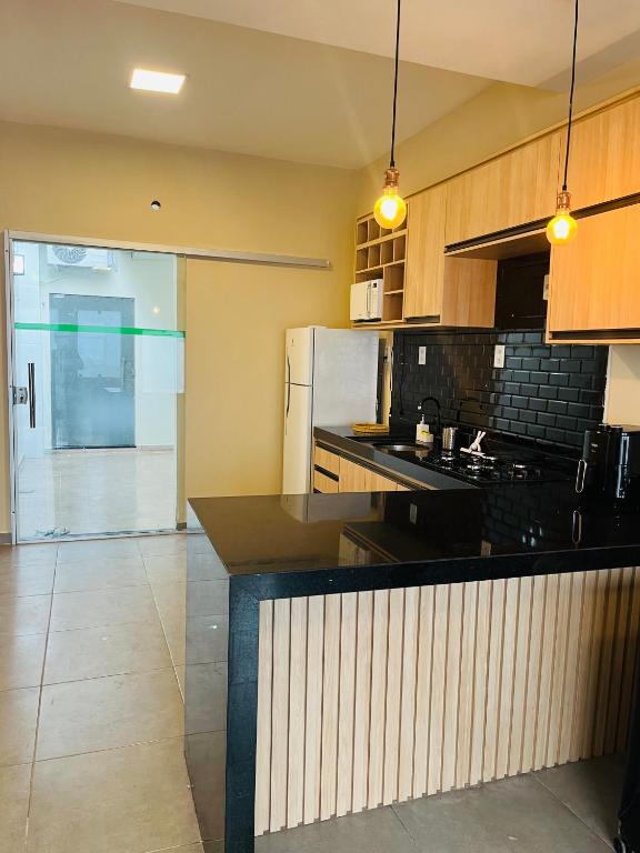 a kitchen with a counter and a refrigerator at Casa Urban 56 - Pet Friendly - Vaga - Cama King in Belém