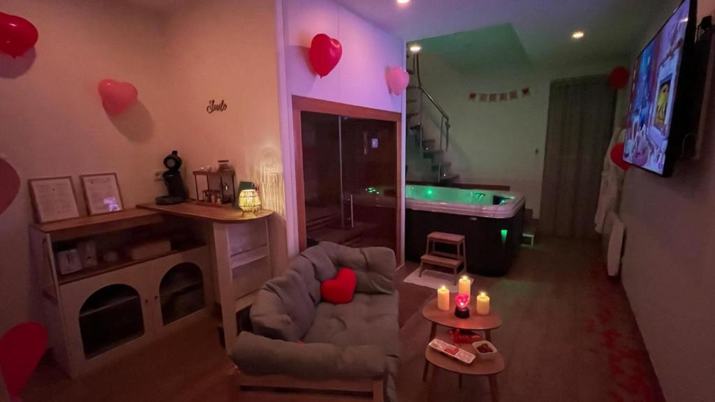 a living room with a room with a tub and a room with a room at Luana SPA Boussois in Boussois