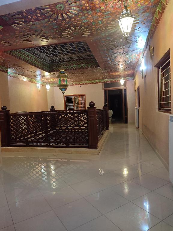 a hallway of a building with a ceiling decorated with flowers at Ryad dar midelt in Midelt