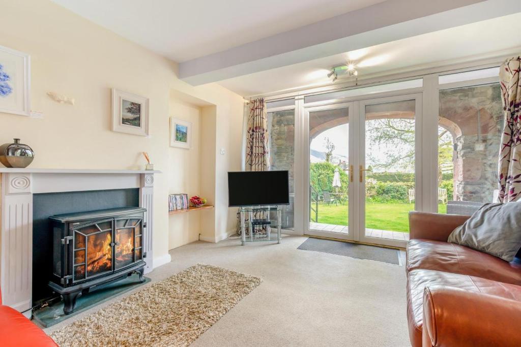 a living room with a fireplace and a tv at 1 Bed in Keswick oc-28382 in Braithwaite