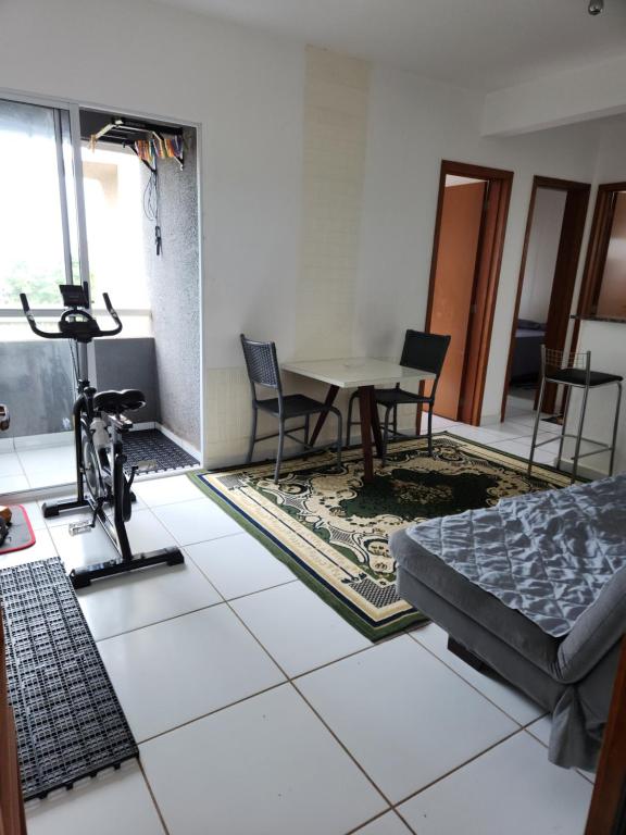 a living room with a table and chairs at Morada Aconchegante com 2 quartos and Sofá Cama in Imperatriz