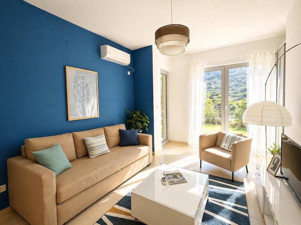 a living room with blue walls and a brown couch at One-Bedroom Apartment with Terrace, Sea View, Pool and Spa Lavender Bay Morinj in Donji Morinj