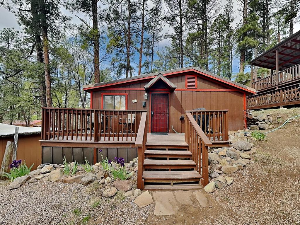 a small house with a staircase leading to a home at A Step Above in Ruidoso