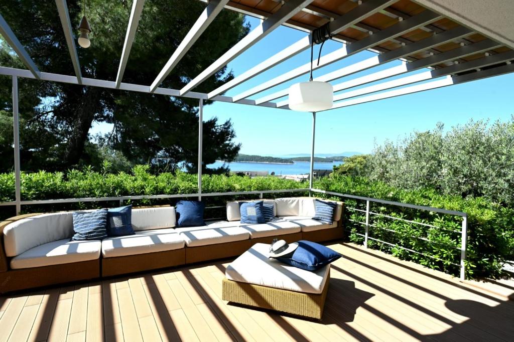 a patio with a couch on a wooden deck at Adriatic Breeze in Hvar