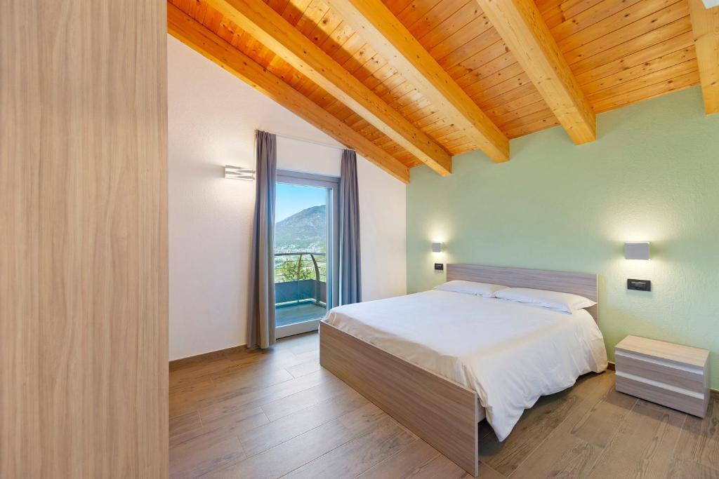 a bedroom with a bed and a large window at Appartamenti Suly 3 - Cir0084 in Saint Vincent