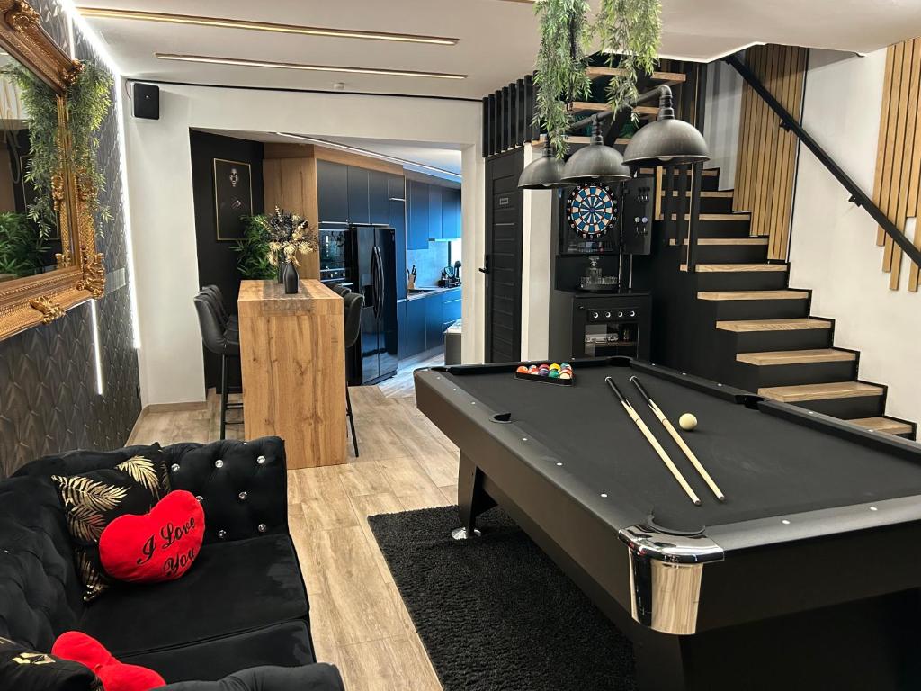 a billiard room with a pool table and stairs at Maison 3 chambres, jacuzzi, billard, sauna, air soccer, clim in Verviers