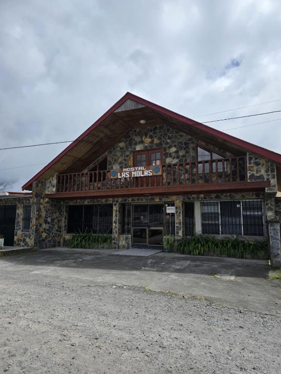 a large building with a gambrel roof at Hostal Las Molas in Volcán