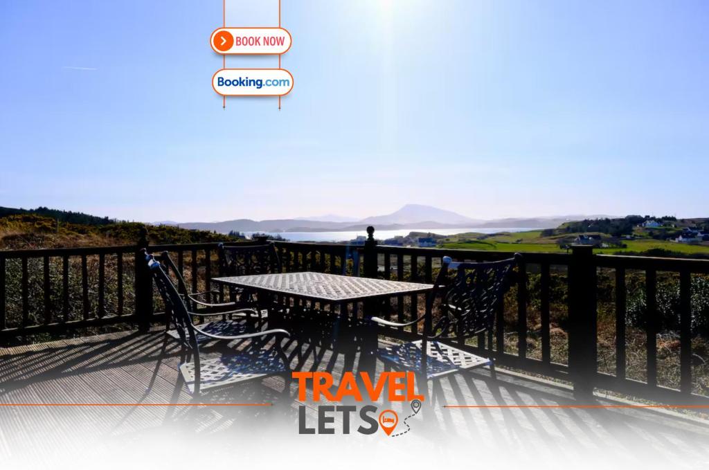 a patio with a table and chairs on a balcony at 4 Bedroom House By Travel Lets Holiday Homes Downings With Atlantic View in Downings