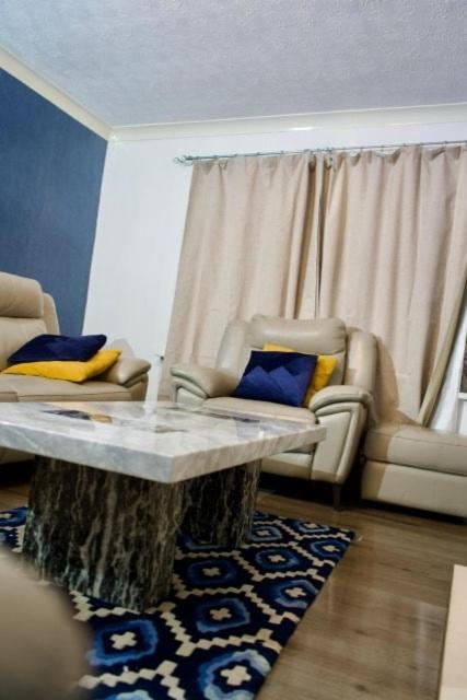 a living room with two chairs and a coffee table at The Bank in West Derby