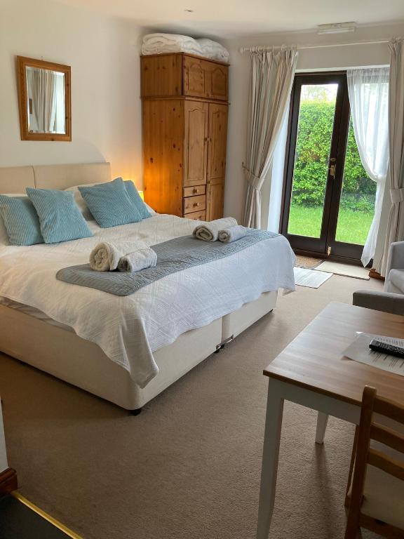 a bedroom with a large bed with towels on it at Church Farm Hartham in Biddlestone
