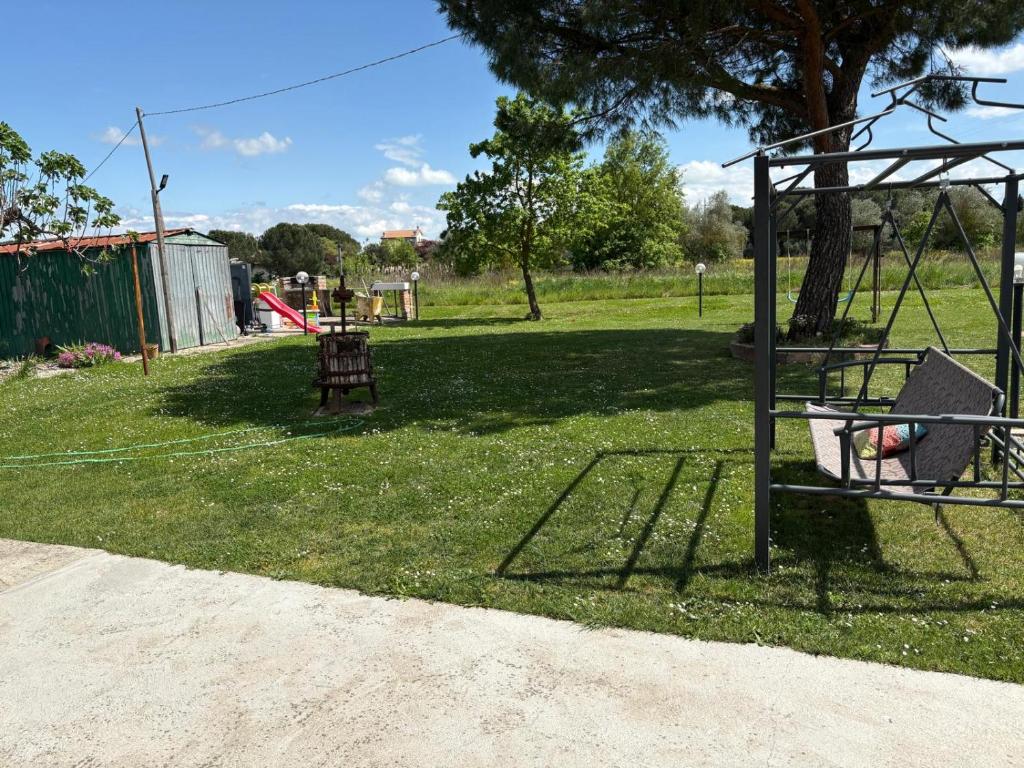 a park with a swing set in the grass at Casa D'Agostino in Cortona