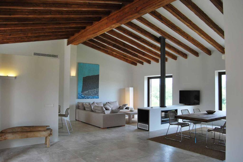 a living room with a couch and a table at Luxury Villa Son Mas in Manacor