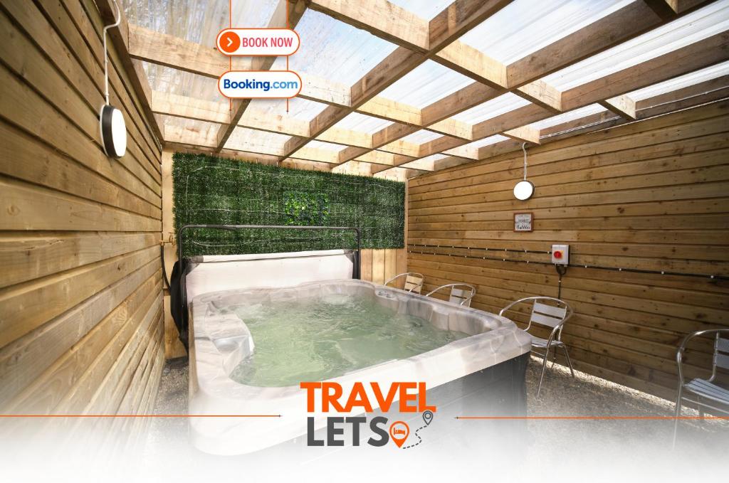a jacuzzi tub in a room with wooden walls at 1 Bedroom Lodge By Travel Lets Self Catering Accommodation Rathmullen With Hot Tub in Ramelton