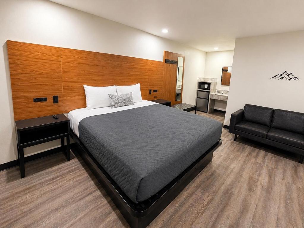 a bedroom with a large bed and a couch at Scenic Motel - El Monte in El Monte