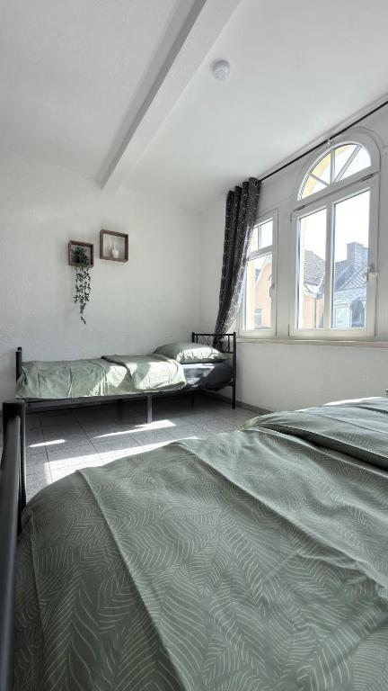 a bedroom with two beds and a window at Construction worker's apartment in Hof in Hof