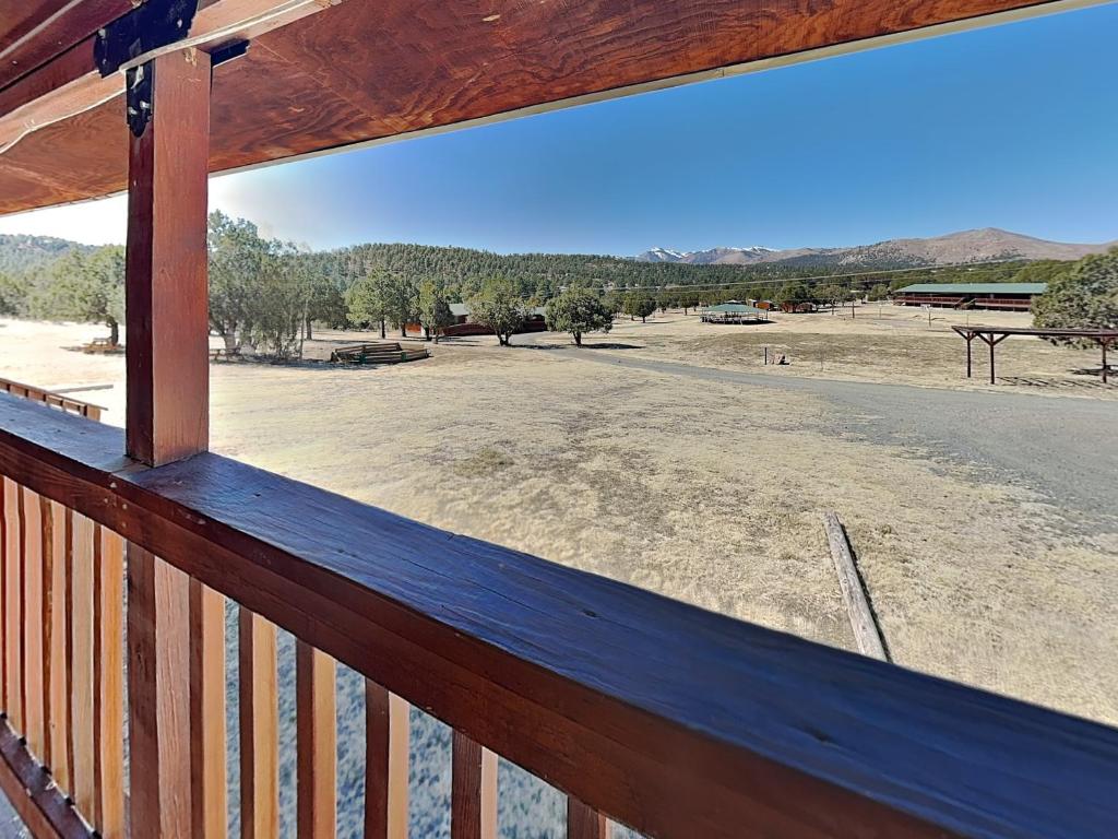a view of a field from a porch at Mountain View Buck Deer Cabinette in Alto