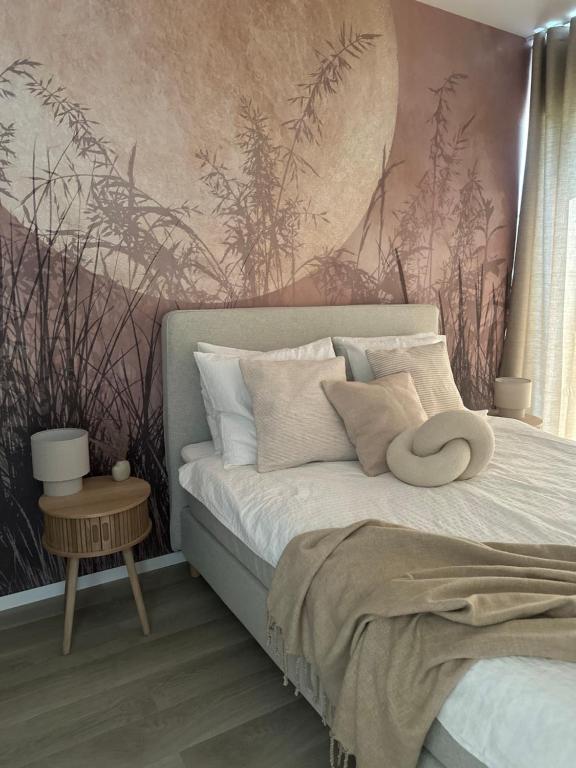 a bedroom with a bed with a wall mural at Port Ostróda 3 - z widokiem na jezioro in Ostróda