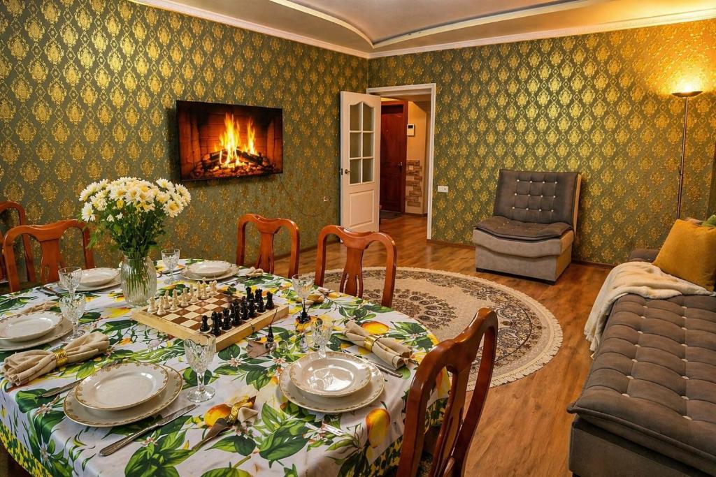 a dining room with a table and a fireplace at Large Appartment & Central Place in Tashkent