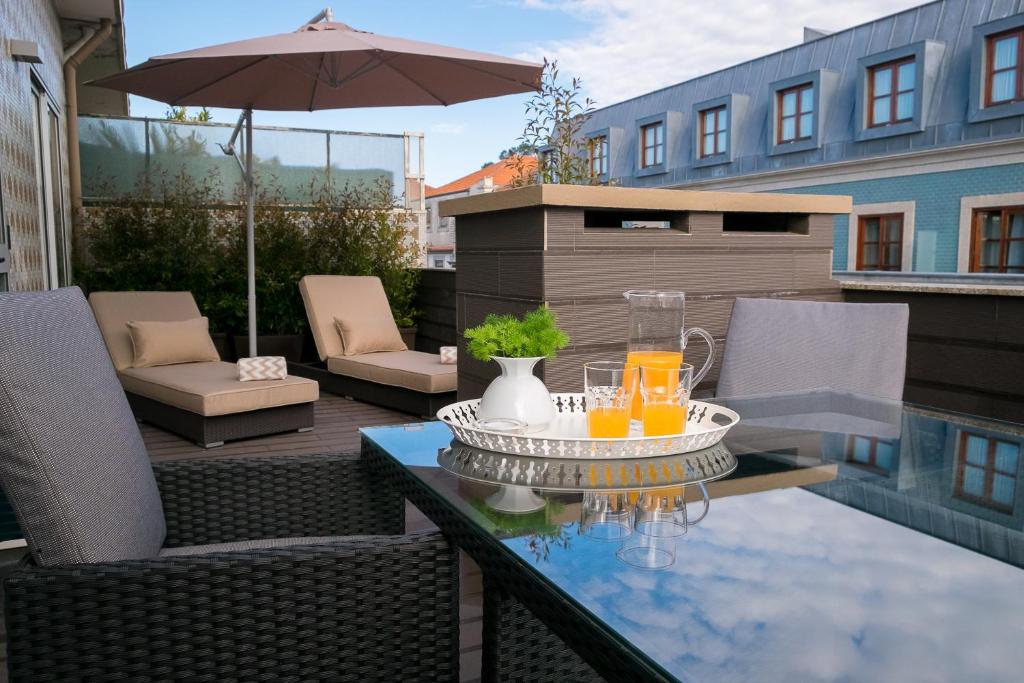 a patio with a table with drinks on it at Simon Guest Apartments in Porto