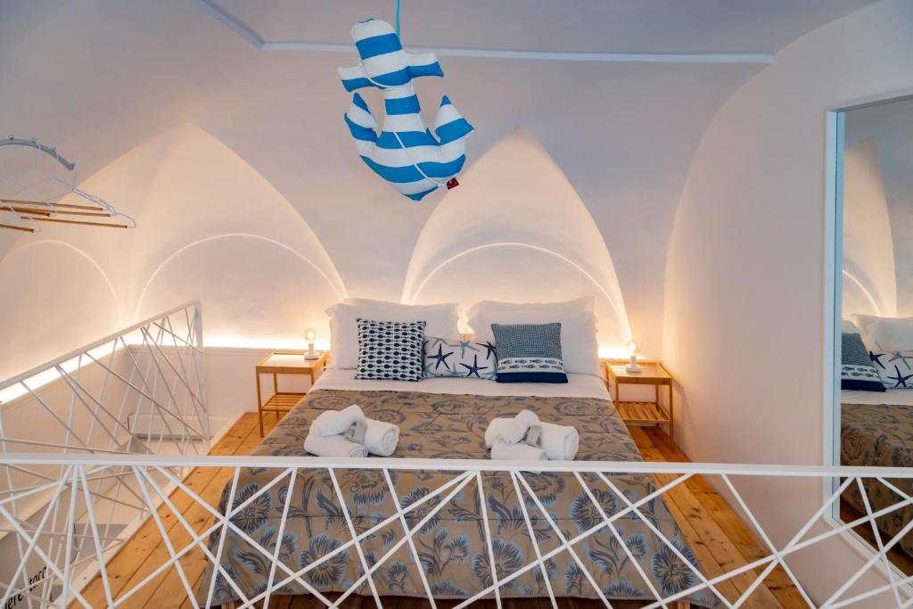 a bedroom with a bed in a room with white walls at Il borgo di Ulisse in Gaeta