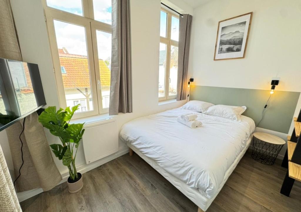 a bedroom with a bed with a teddy bear on it at Studio cosy Amiens in Amiens