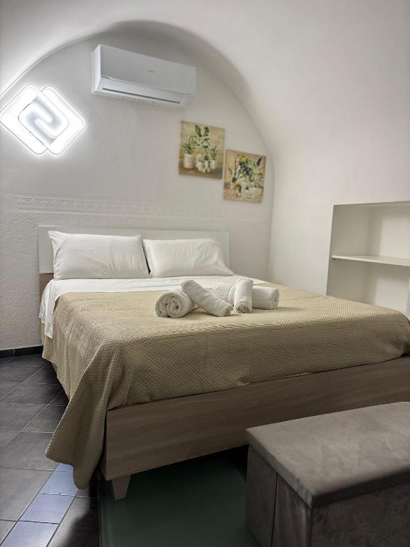 a bedroom with a large bed with towels on it at B&B Fiore di Maggio in Mola di Bari