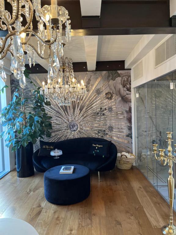 a living room with a couch and a chandelier at ca' squero911 luxury rooms in Cesenatico