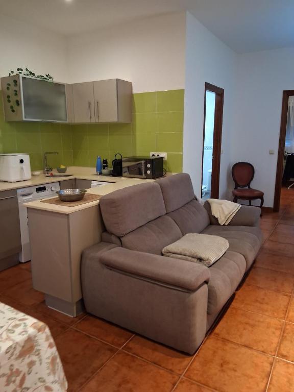 a living room with a couch and a kitchen at Garro1 in Pasajes Ancho