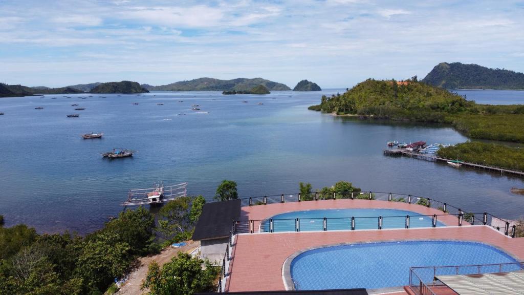 a view of a body of water with boats in it at Pandan View Mandeh Syariah in Pasarsungai-nyala