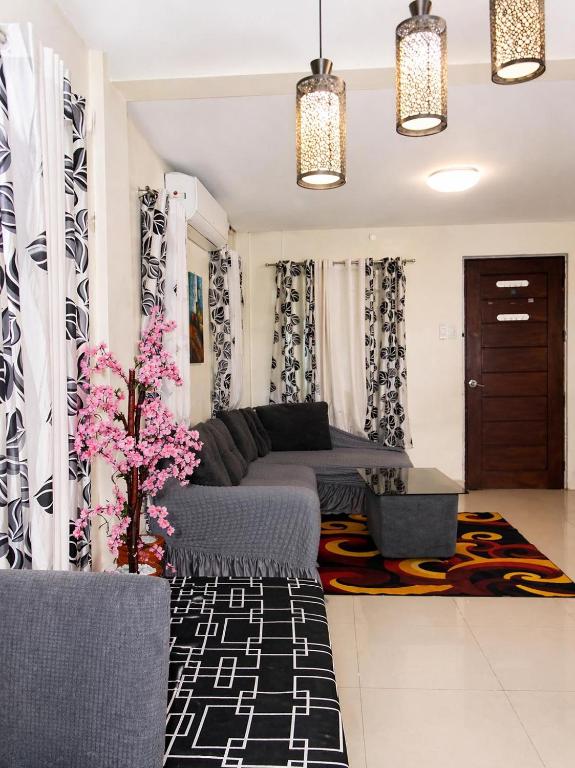 a living room with a couch and a table at Affordable MODERN Up to 16 Pax Near Aqua Planet & Clark International Airport in Angeles
