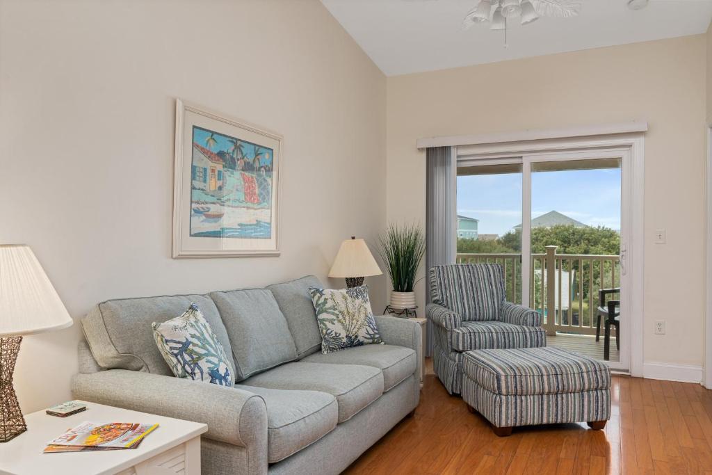 a living room with a couch and a chair at Dreamer by Oak Island Accommodations in Oak Island