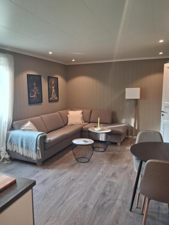 a living room with a couch and tables at Leilighet i Lyngdal in Lyngdal