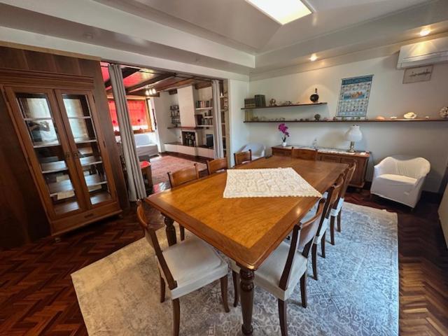 a dining room with a wooden table and chairs at La Casa Gialla in Caorle