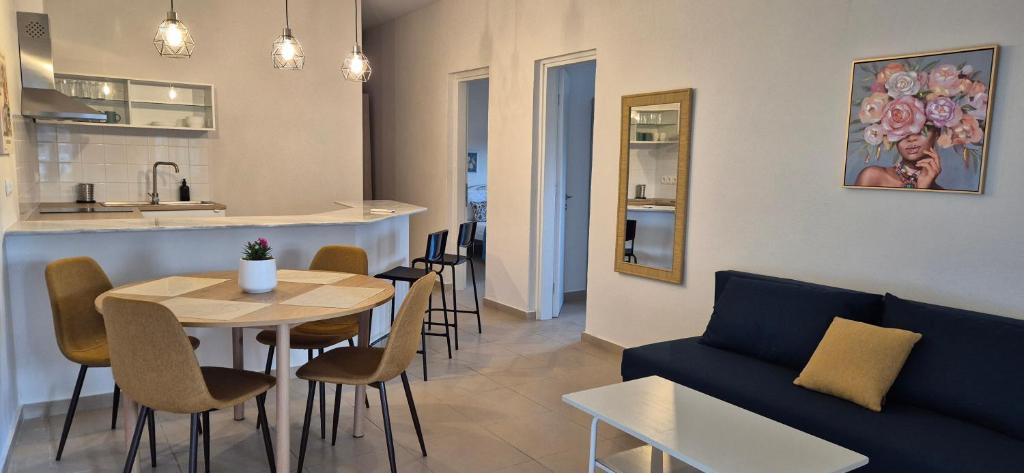 a living room with a couch and a table and chairs at Apartment K2 in Pyrgi